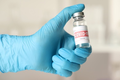 Doctor with coronavirus vaccine in laboratory, closeup