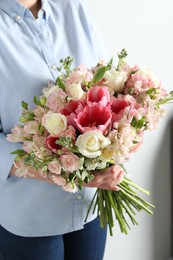 Photo of Woman with beautiful bouquet of fresh flowers indoors, closeup