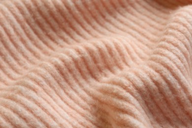 Photo of Beautiful pale pink knitted fabric as background, closeup