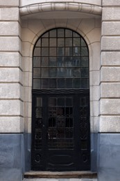 Photo of Entrance of house with beautiful arched door and transom window