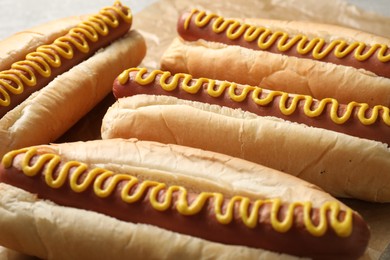 Fresh delicious hot dogs with mustard, closeup view