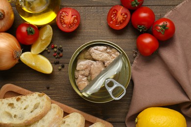 Flat lay composition with tin can of tasty cod liver and different products on wooden table