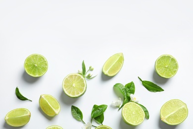 Photo of Composition with fresh ripe limes on white background, top view