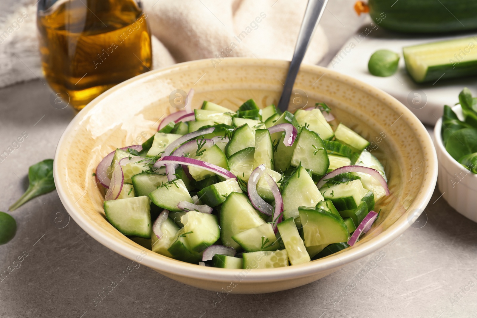 Photo of Plate with tasty cucumber salad on table