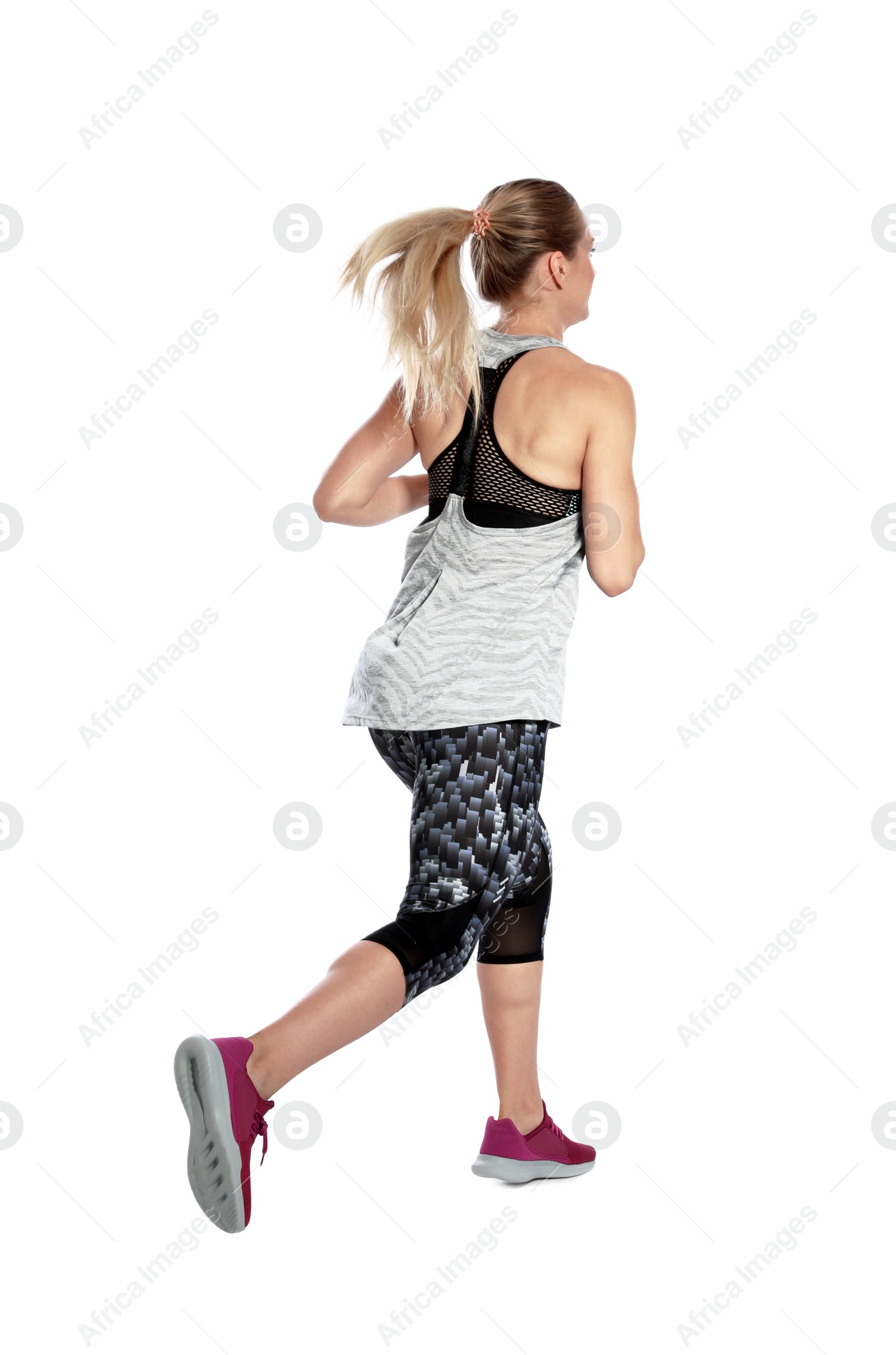 Photo of Sporty young woman running on white background