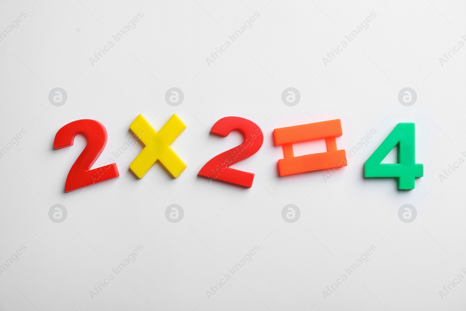 Photo of Math equation of magnetic numbers and symbols on white background, top view