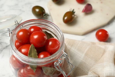 Photo of Pickling jar with fresh ripe cherry tomatoes on table, closeup. Space for text