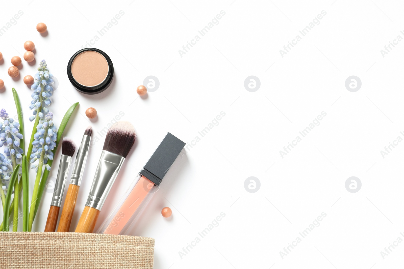 Photo of Makeup products and cosmetic bag on white background, top view