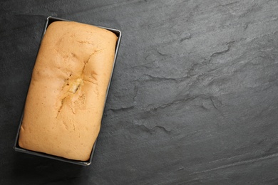 Photo of Tasty pear bread on black slate table, top view
 with space for text. Homemade cake