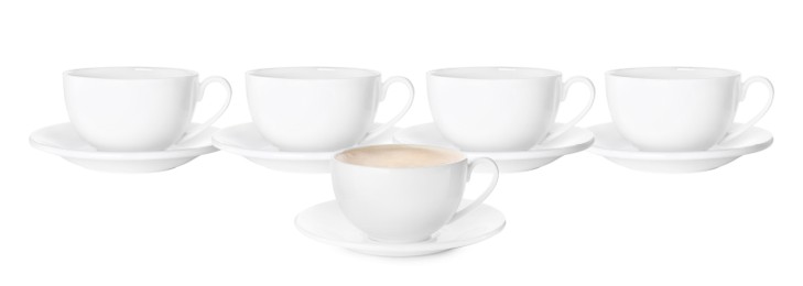 Image of Empty ceramic cups and one with aromatic coffee on white background. Banner design