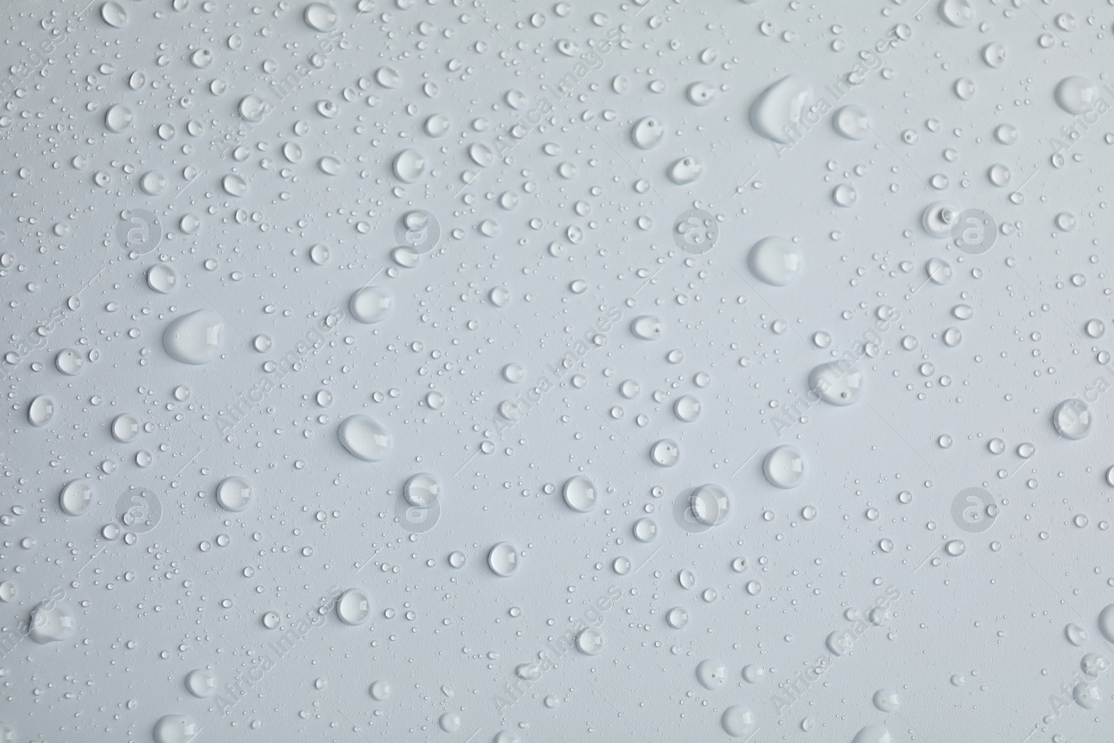 Photo of Many clean water drops on light background