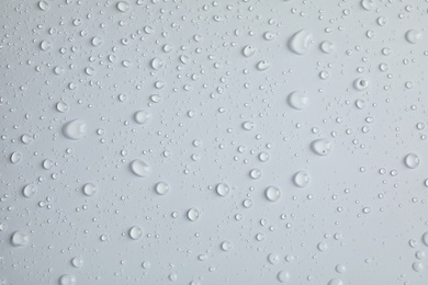 Many clean water drops on light background