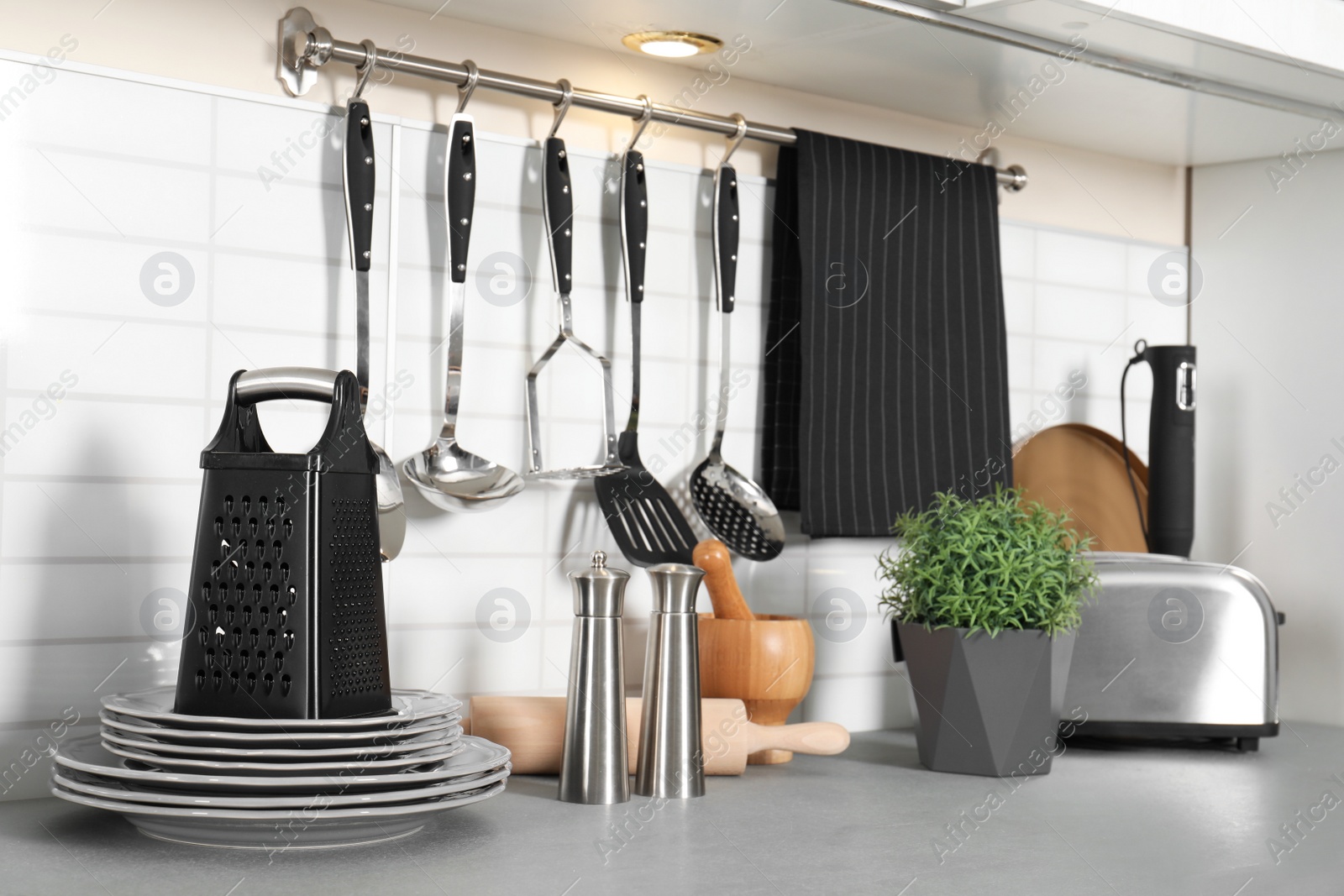 Photo of Different appliances, clean dishes and utensils on kitchen counter