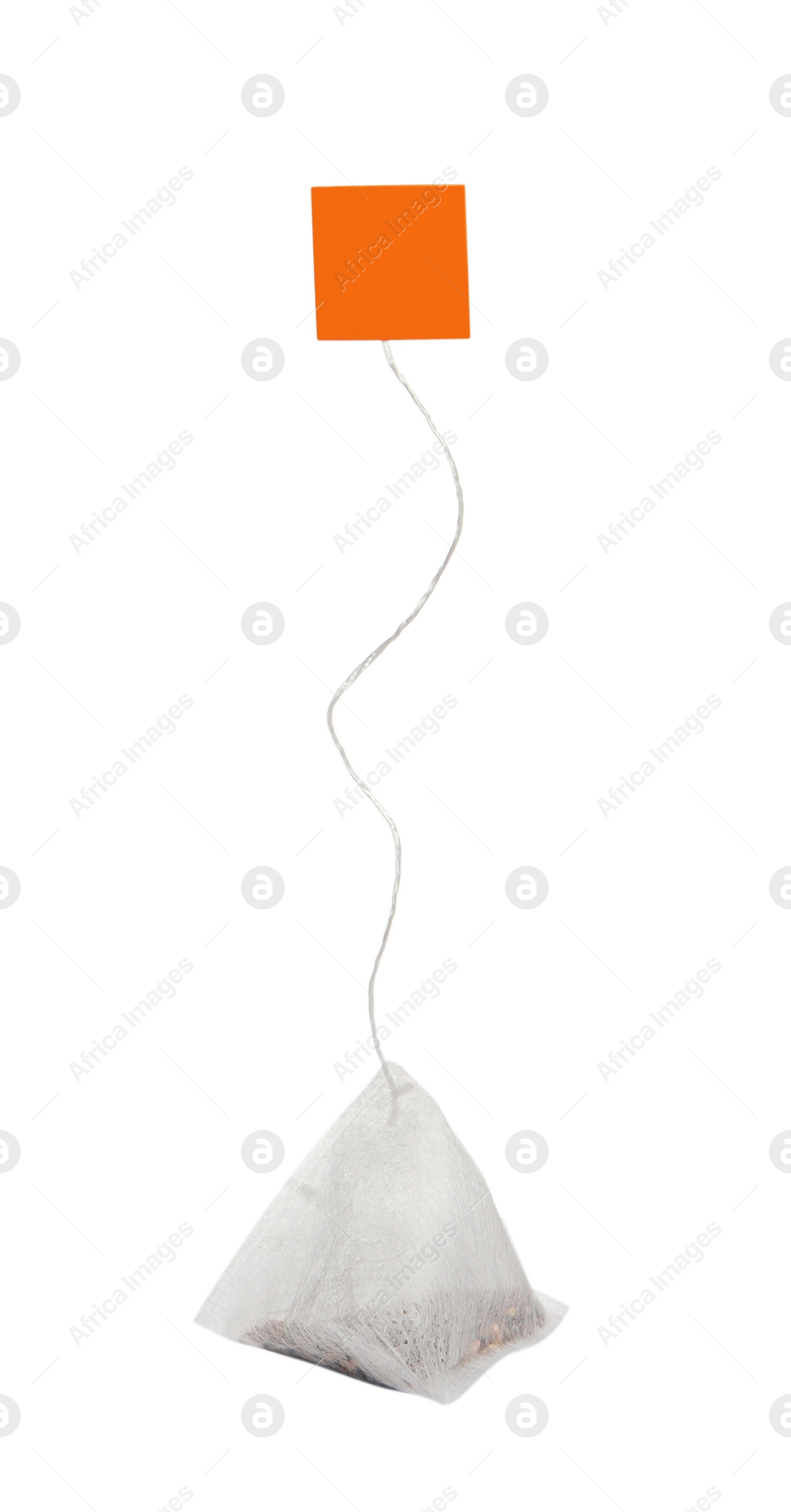 Photo of Paper tea bag with tag isolated on white