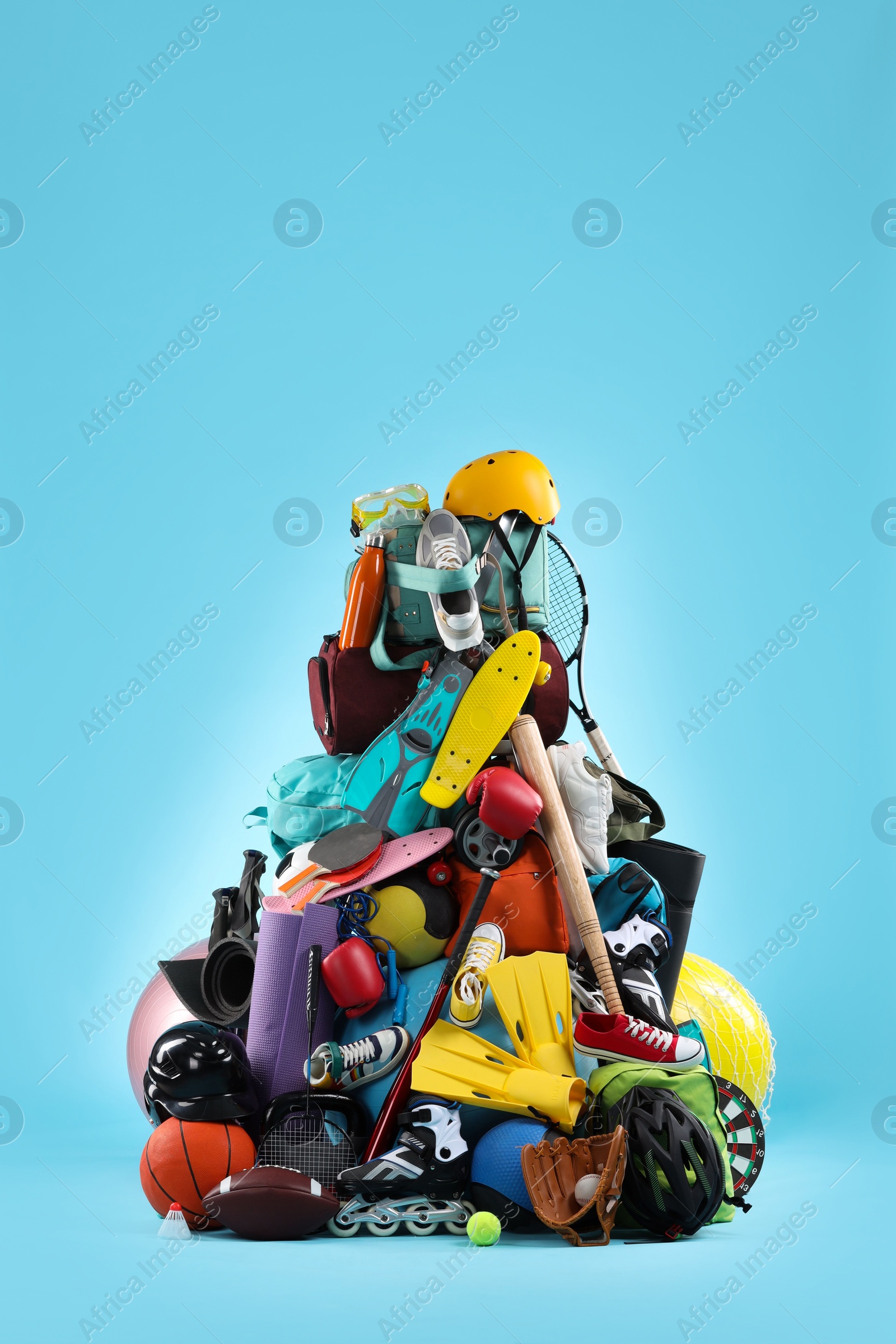 Photo of Many different sports equipment on light blue background