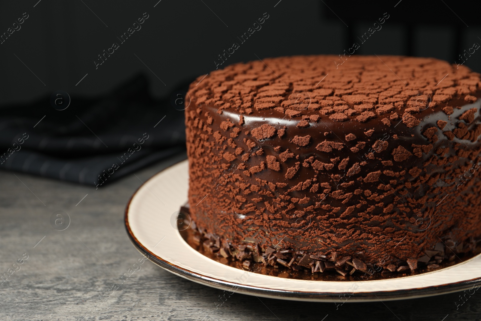 Photo of Delicious chocolate truffle cake on grey textured table