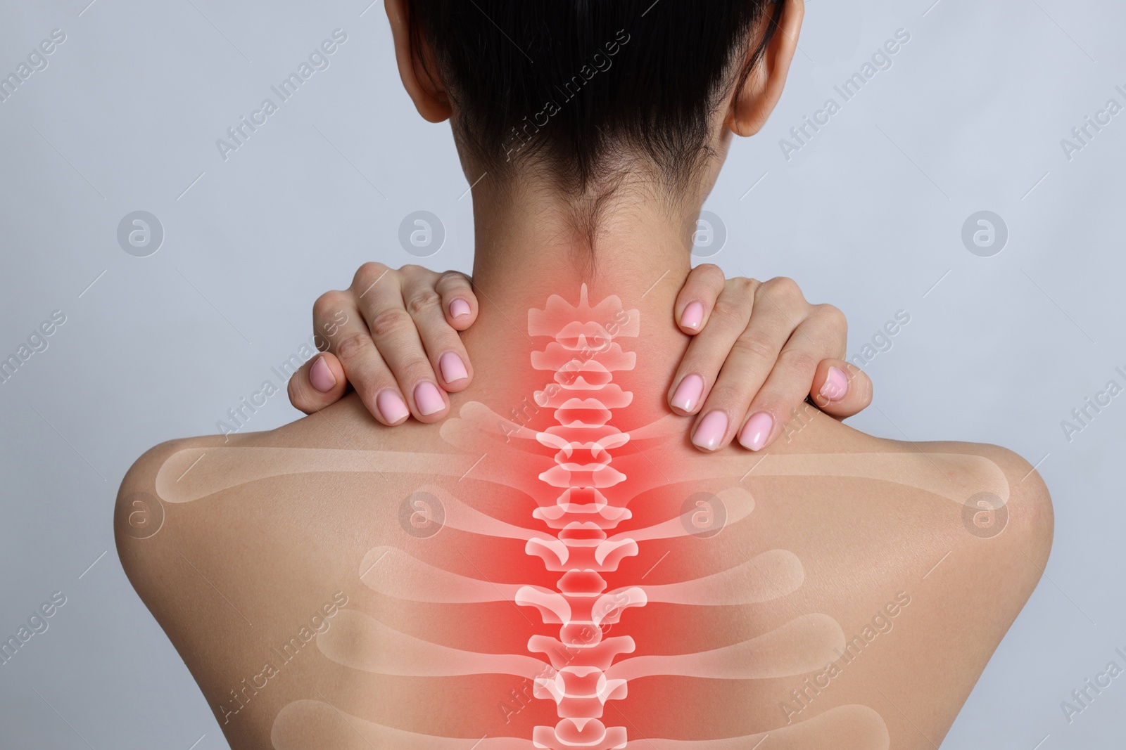 Image of Woman suffering from pain in neck on light grey background, closeup