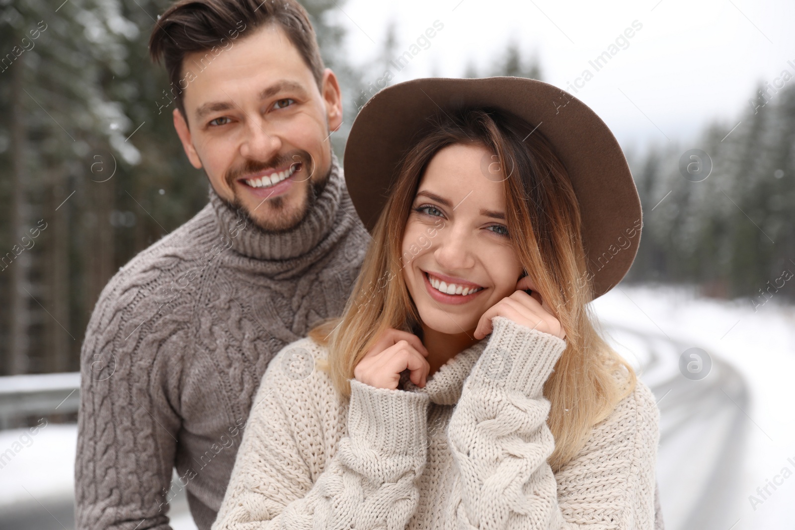 Photo of Cute couple outdoors on snowy day. Winter vacation