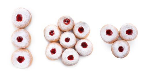 Set of Hanukkah doughnuts with jelly and sugar powder on white background, top view