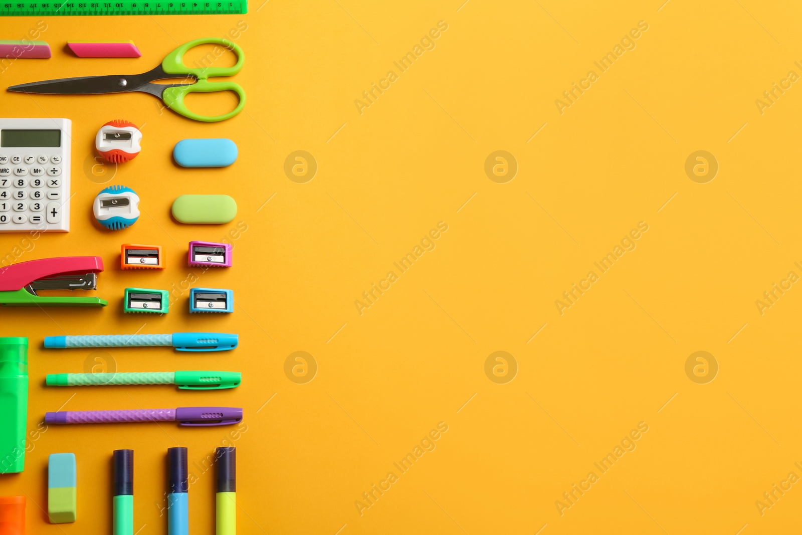 Photo of School stationery on yellow background, flat lay with space for text. Back to school