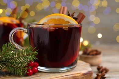 Aromatic mulled wine on wooden board, closeup