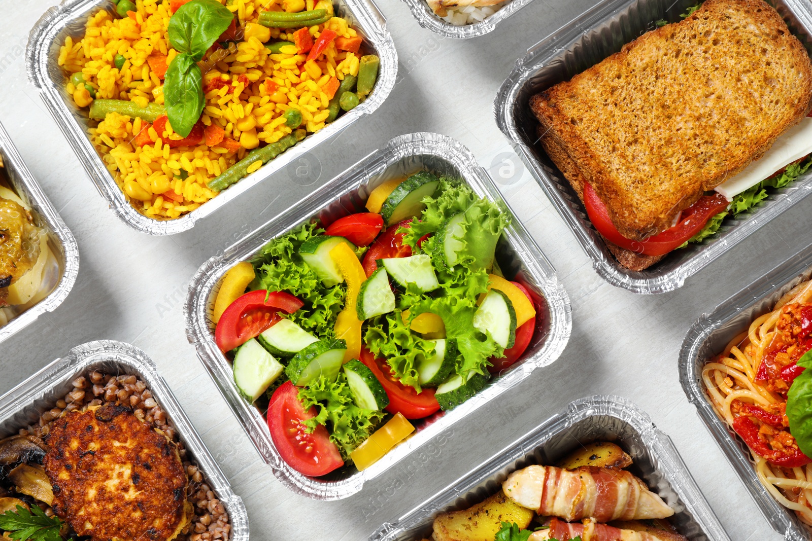 Photo of Lunchboxes on white wooden table, flat lay. Healthy food delivery