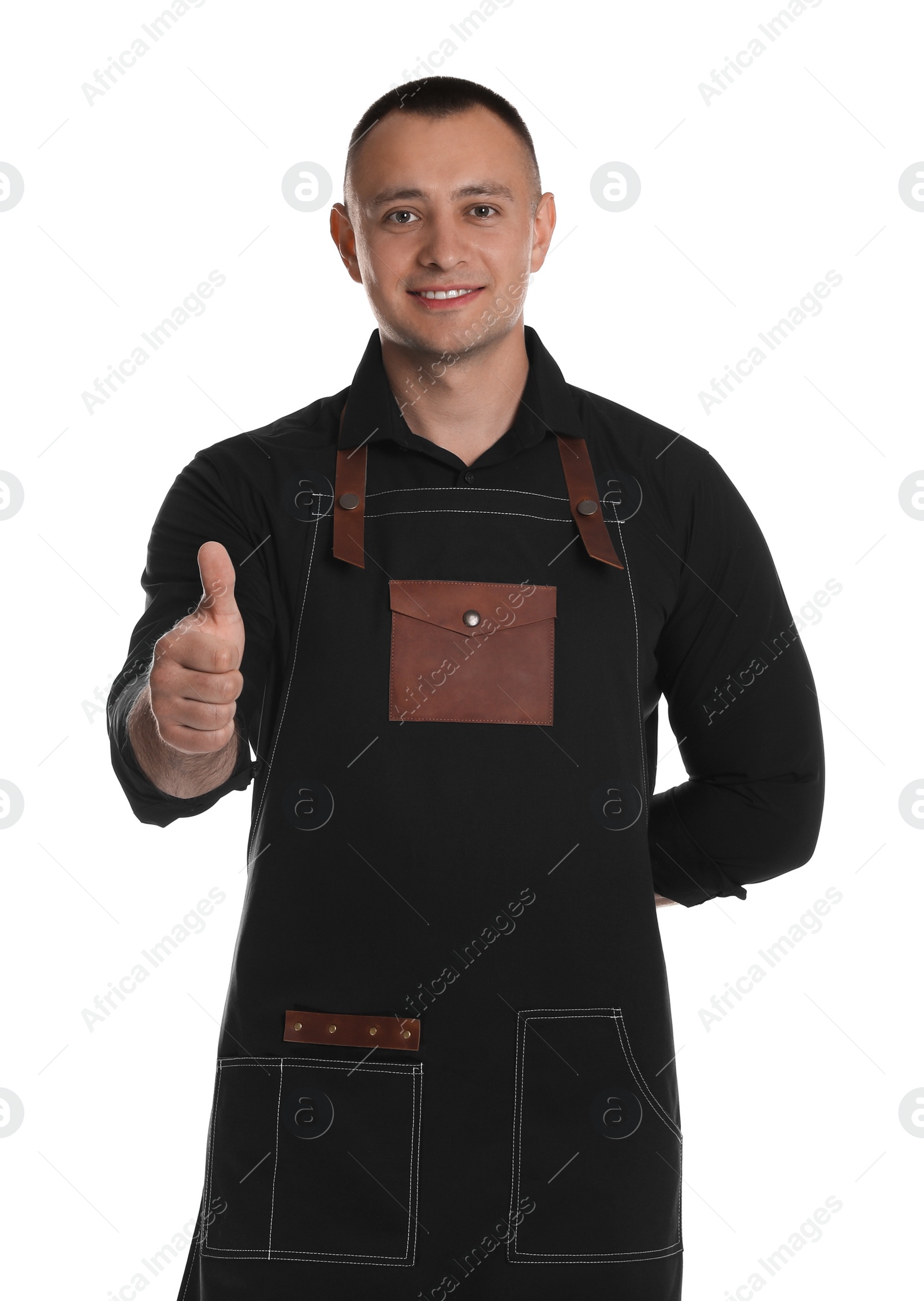 Photo of Portrait of happy young waiter showing thumb up on white background