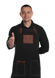 Photo of Portrait of happy young waiter showing thumb up on white background