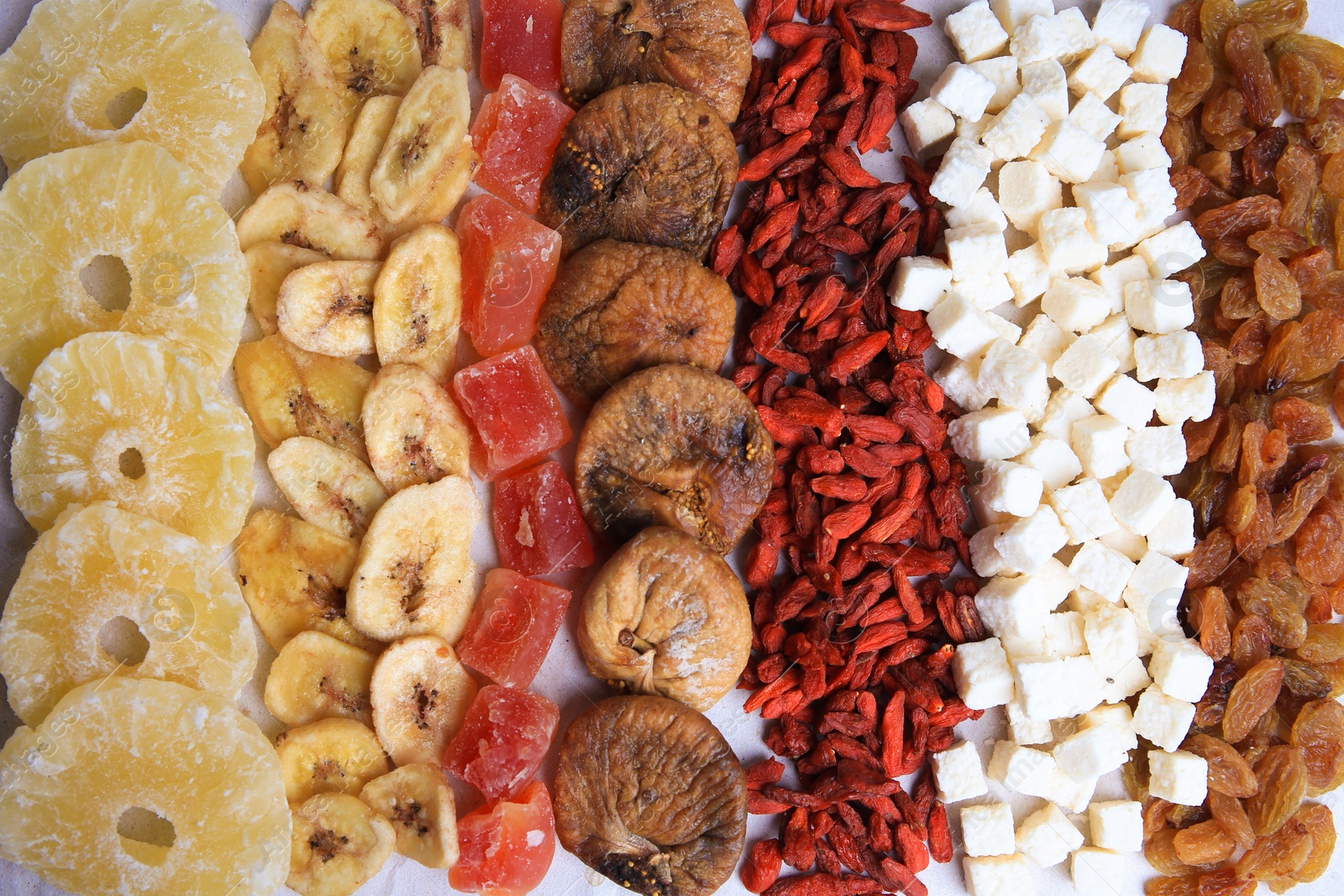 Photo of Different tasty dried fruits as background, top view