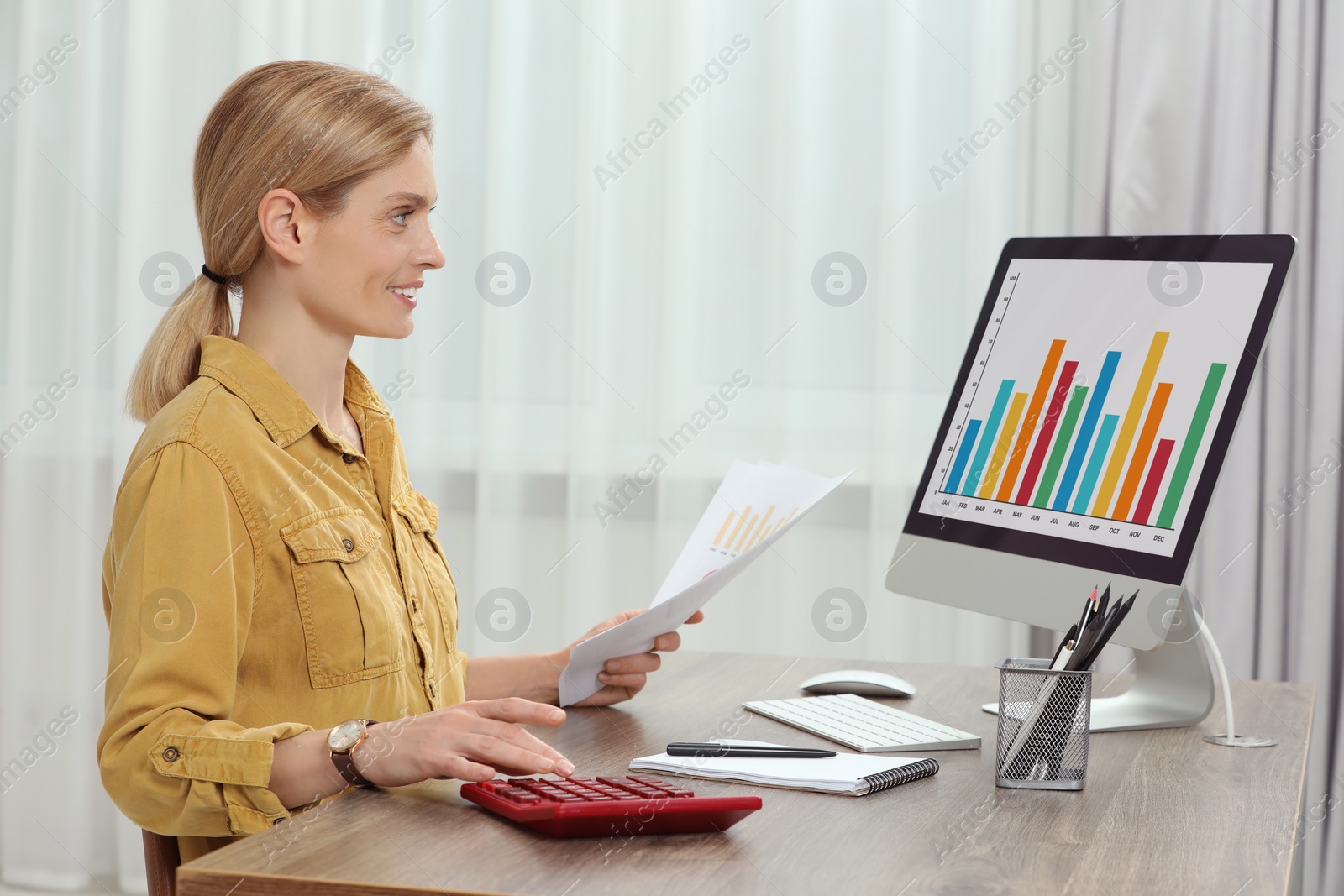 Photo of Professional accountant working at wooden desk in office