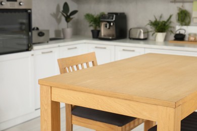 Stylish wooden table with chairs in kitchen. Interior design