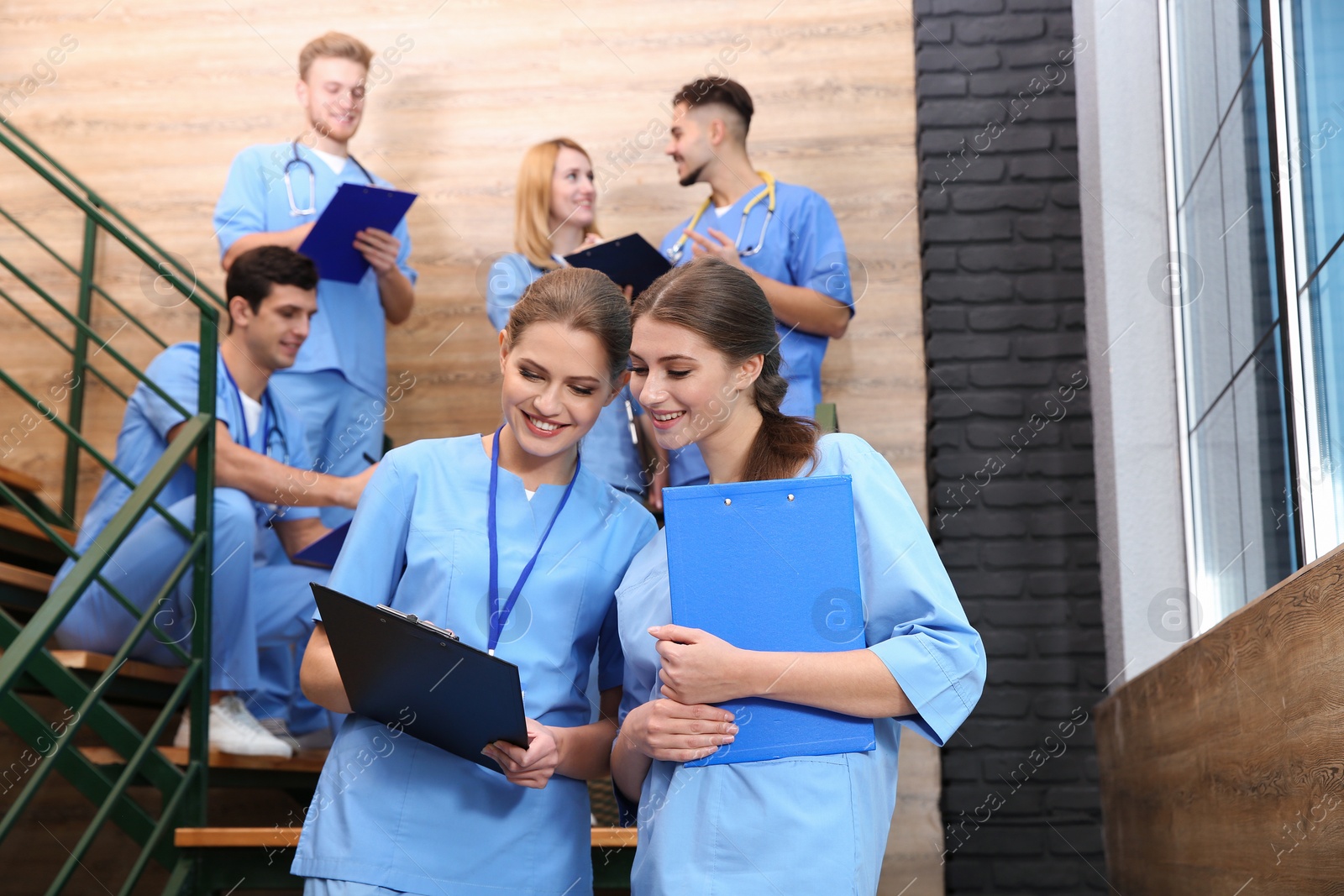 Photo of Young smiling medical students in university hall