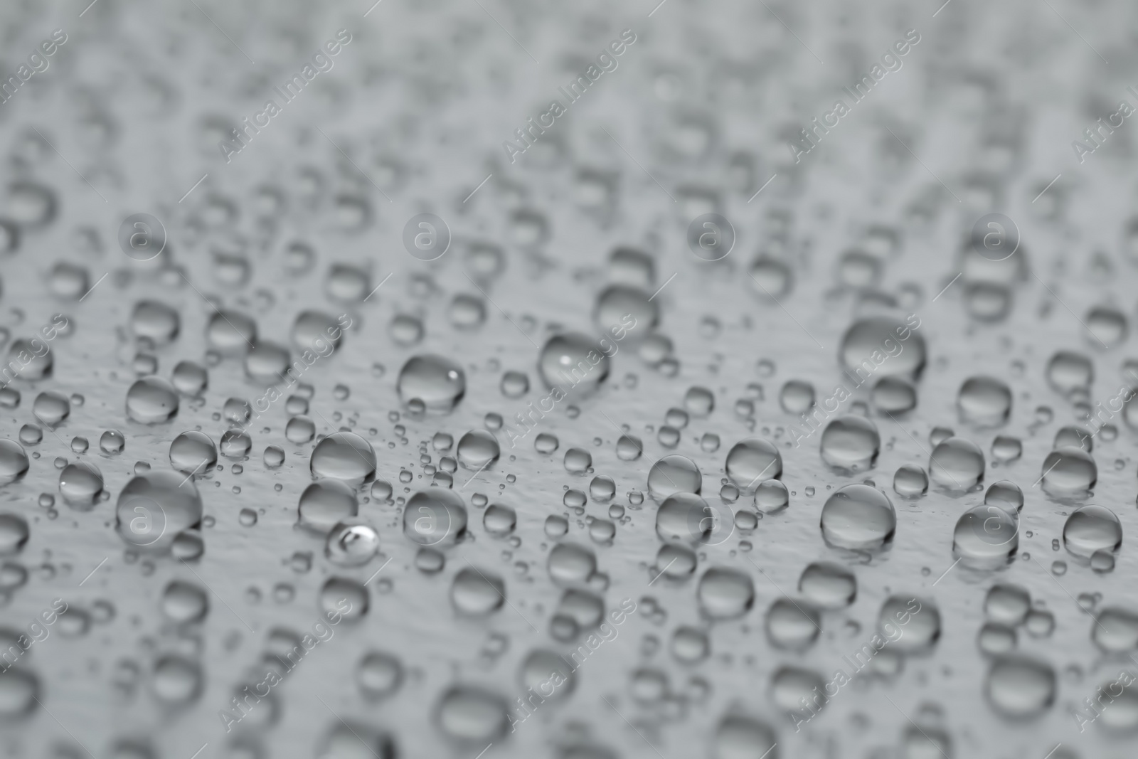 Photo of Water drops on grey background, closeup view