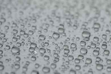 Photo of Water drops on grey background, closeup view