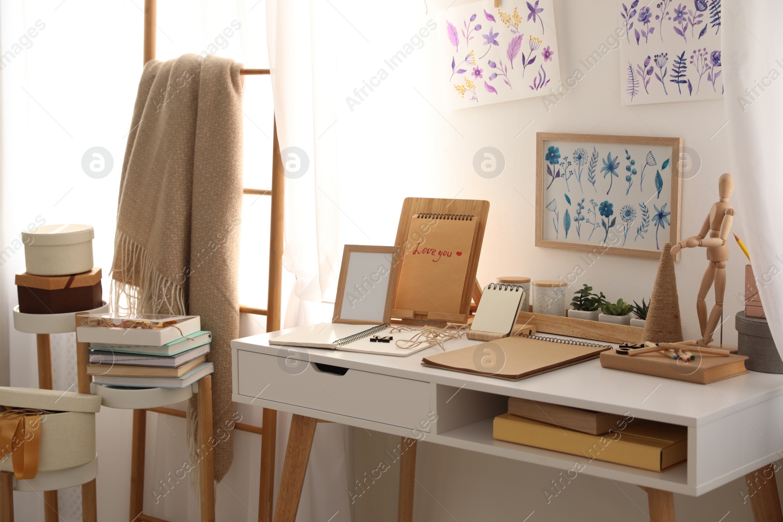 Photo of Stylish room interior with creative workplace near white wall