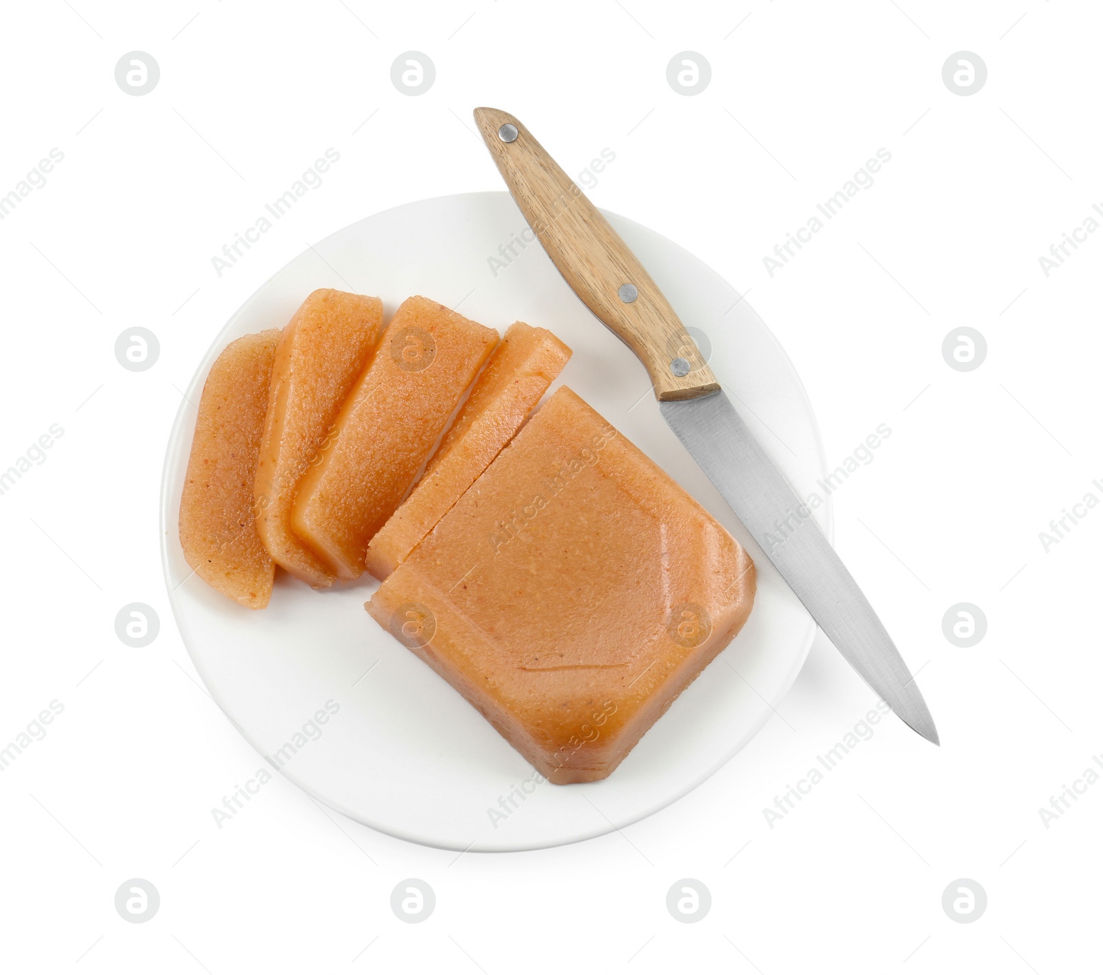 Photo of Delicious sweet quince paste and knife isolated on white, top view