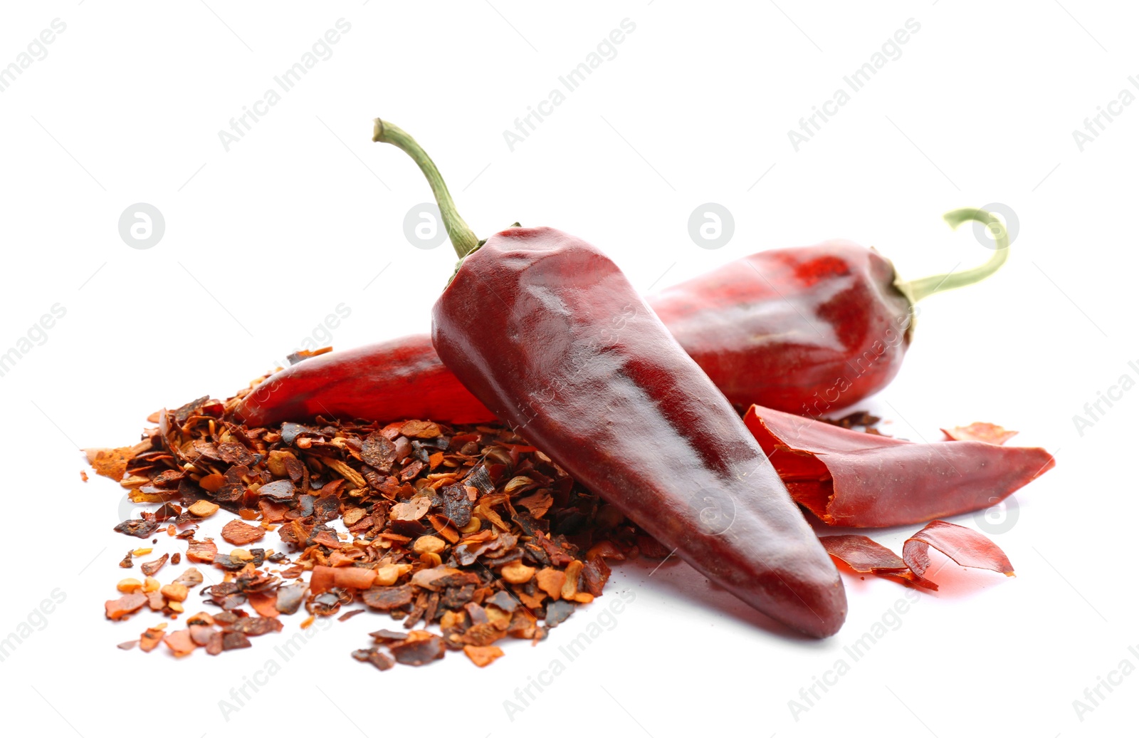 Photo of Composition with chili pepper flakes on white background