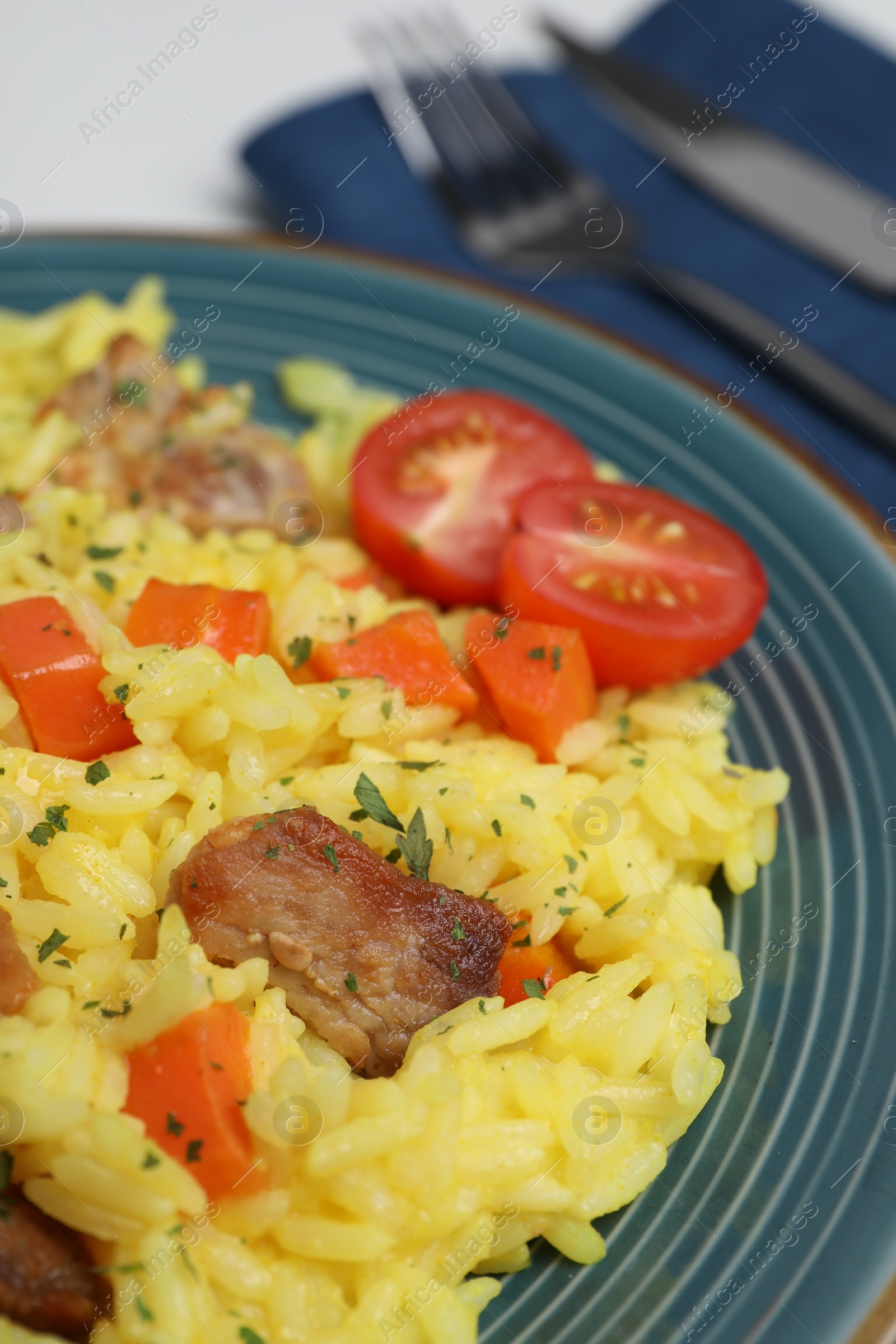 Photo of Delicious pilaf with meat and tomatoes on plate, closeup