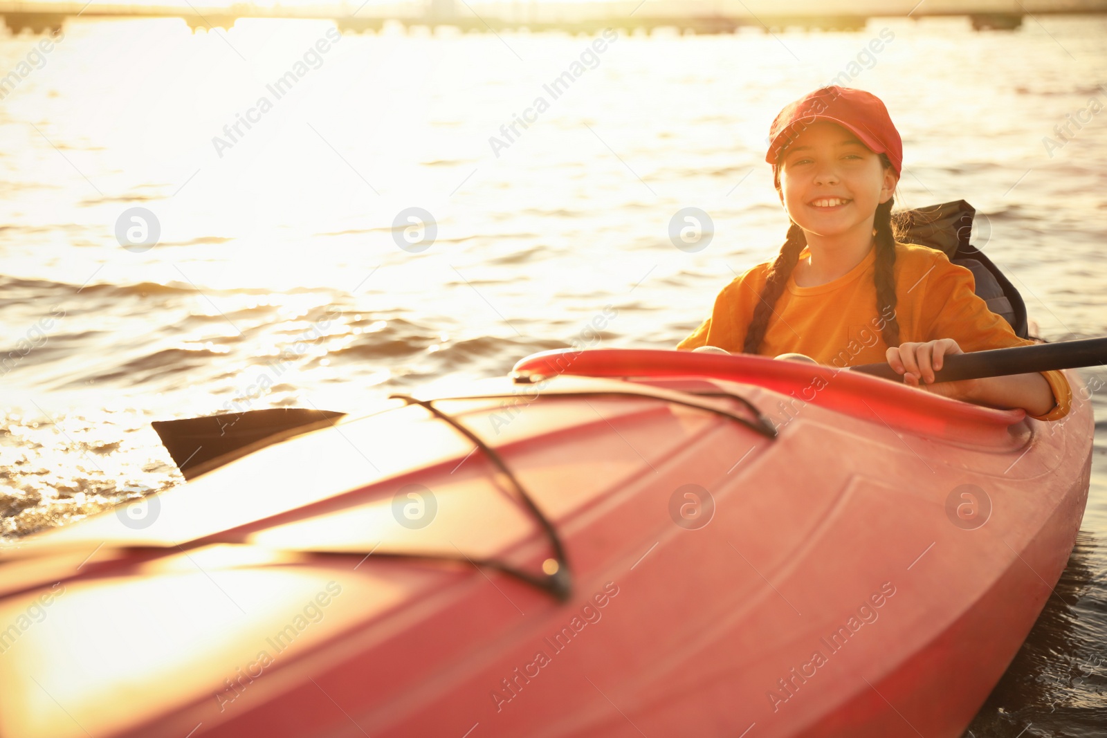 Photo of Happy girl kayaking on river. Summer camp activity