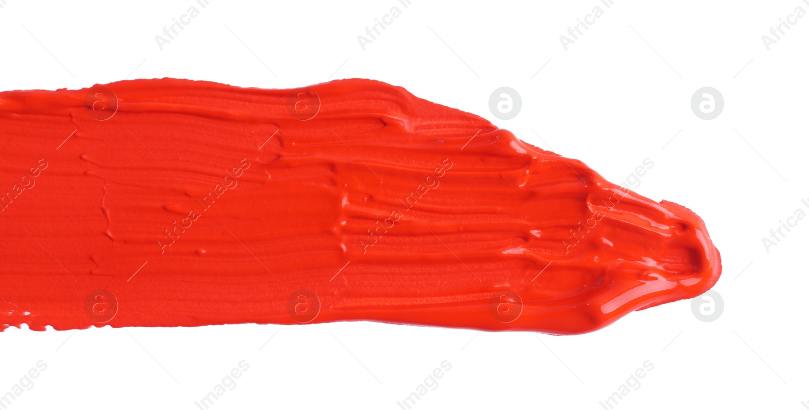 Photo of Red paint stroke drawn with brush on white background, top view