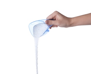 Woman pouring laundry detergent from measuring container against white background, closeup