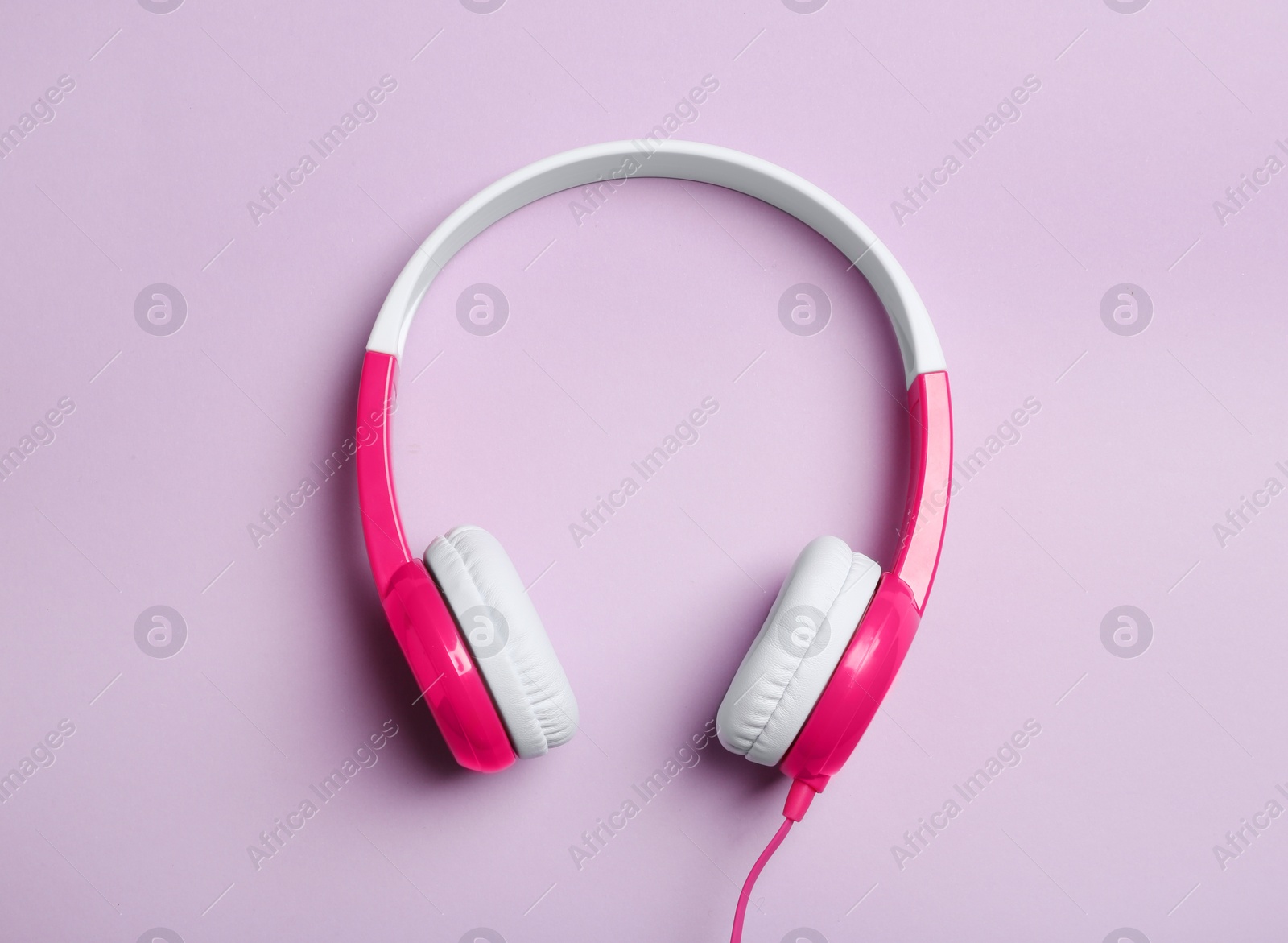 Photo of Stylish headphones on color background, top view