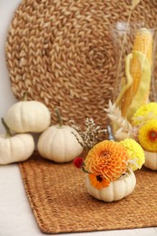 Photo of Composition with small pumpkins and beautiful flowers on table