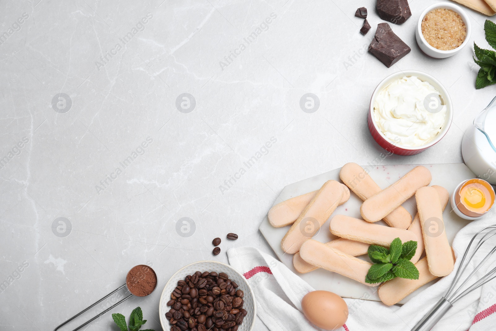 Photo of Flat lay composition with tiramisu ingredients on light grey table, space for text