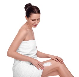 Photo of Beautiful woman with smear of body cream on her leg against white background