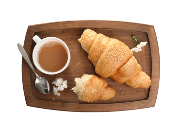 Wooden tray with tasty croissants and cup of coffee on white background