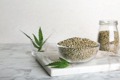 Bowl of hemp seeds on marble table