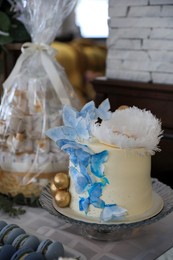 Beautiful delicious decorated cake on table indoors