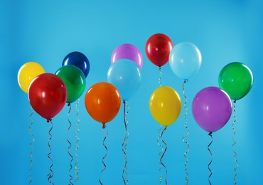 Bright balloons on color background. Celebration time