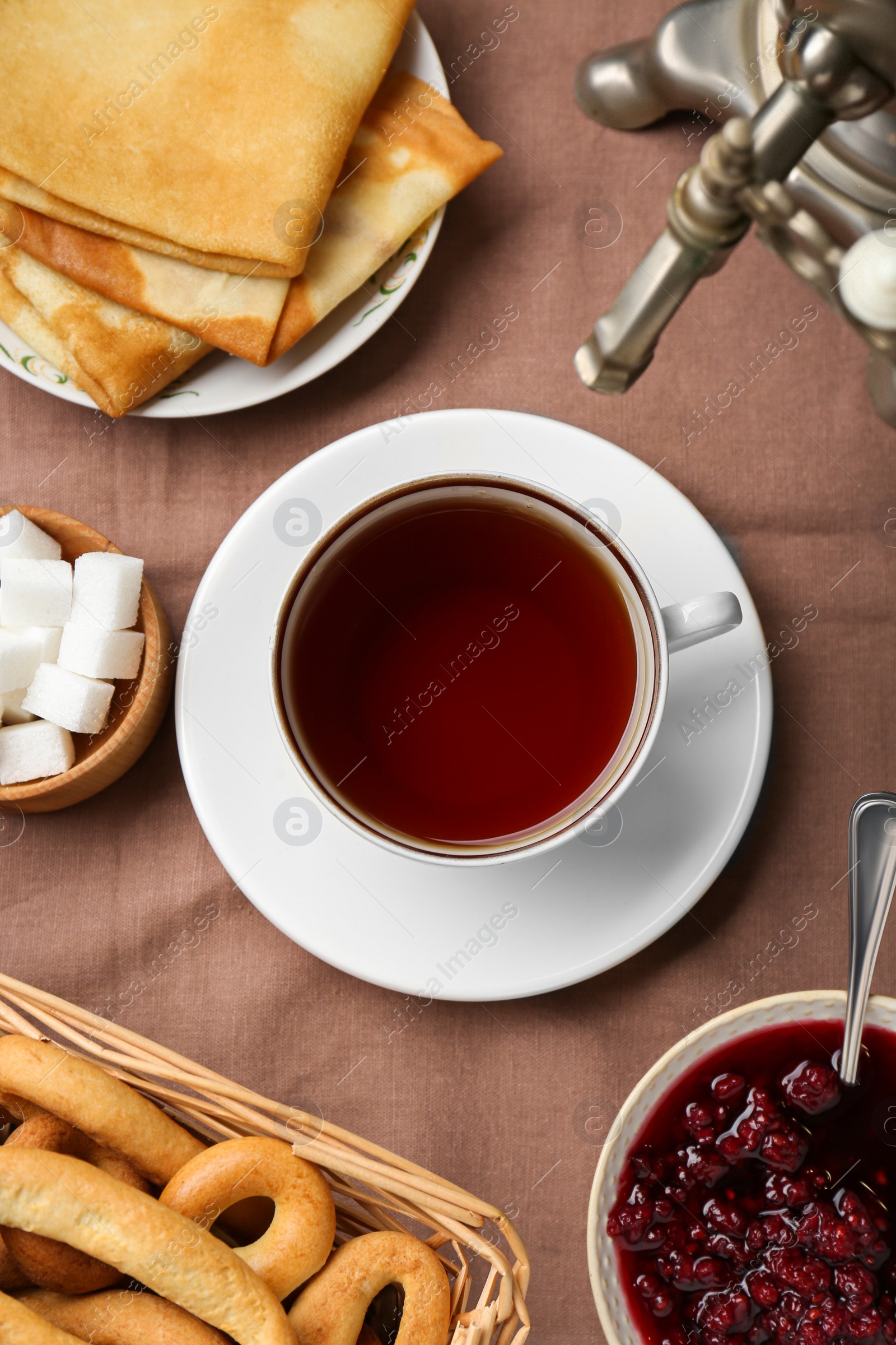 Photo of Flat lay composition with aromatic tea and treats on table